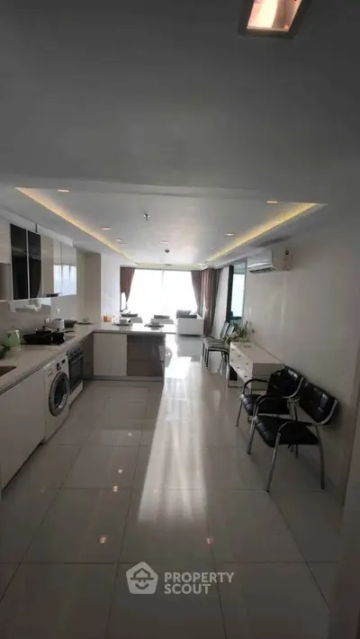 Spacious modern kitchen with open layout and bright living area