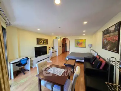 Spacious studio apartment with modern furnishings and open layout, featuring a cozy living area and stylish decor.