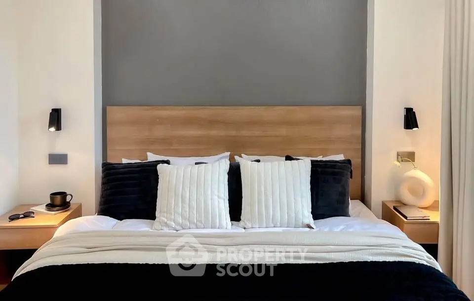 Luxurious bedroom with modern decor and cozy bedding in a stylish real estate property.