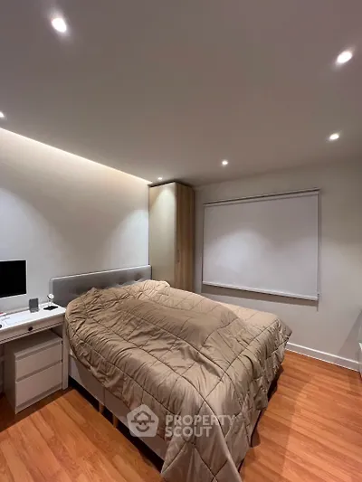 Modern bedroom with cozy lighting and sleek wooden flooring