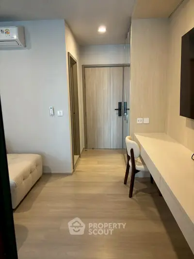 Modern apartment hallway with sleek wooden flooring and stylish furniture