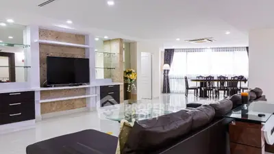 Spacious modern living room with sleek furniture and dining area, perfect for entertaining.