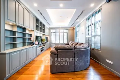 Spacious living room with modern sectional sofa and built-in shelving