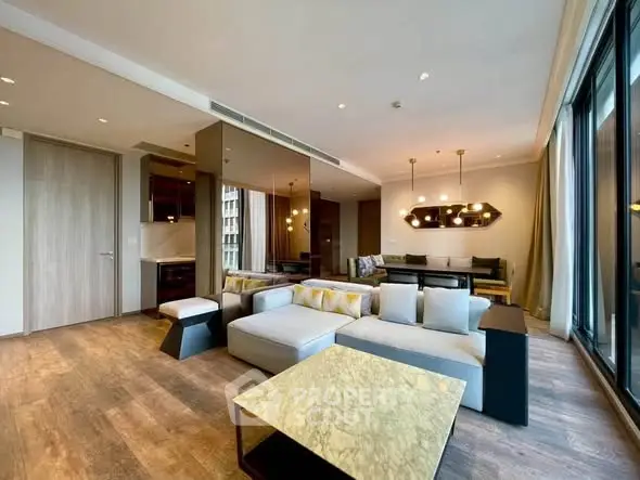 Spacious modern living room with elegant decor and large windows in luxury apartment.