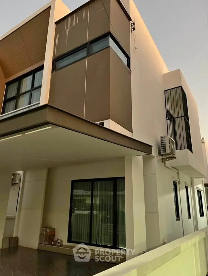 Modern two-story house exterior with sleek design and large windows