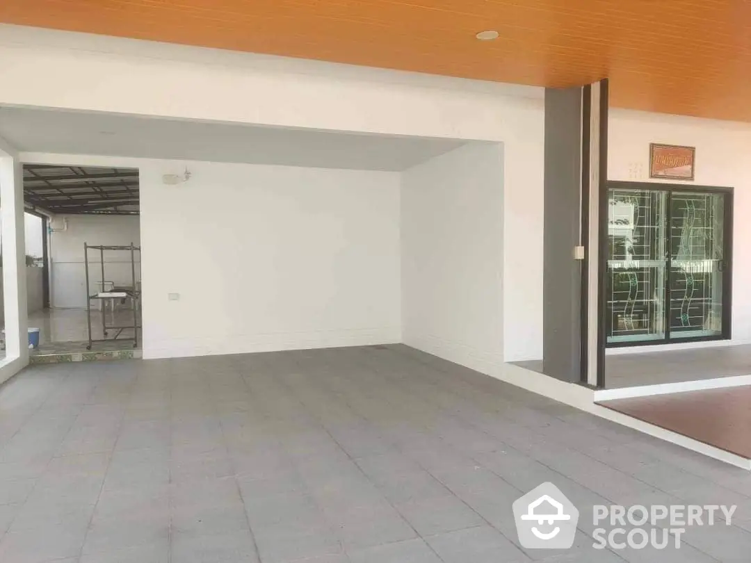 Spacious and modern open layout living area with large tiles, ample natural light, and a seamless flow to the outdoor space, perfect for entertaining and relaxation.