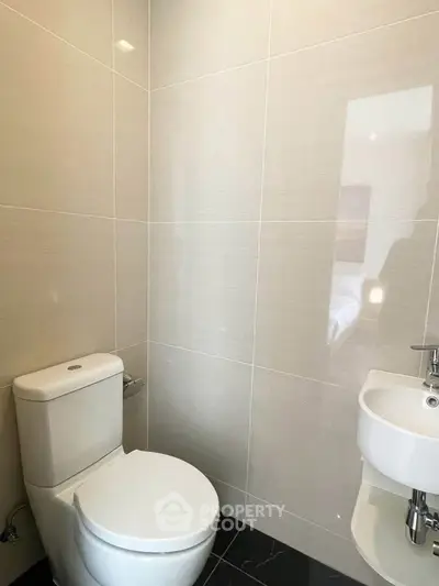 Modern bathroom with sleek design and compact fixtures.