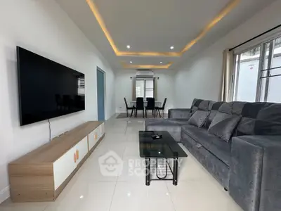 Spacious modern living room with sleek furniture and ambient lighting