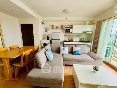 Spacious living room with modern kitchen and balcony view in a stylish apartment.