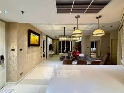 Luxurious open-plan living and dining area with elegant lighting and modern decor.