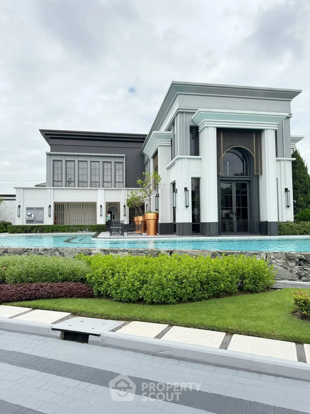 Luxurious modern mansion with elegant architecture and stunning pool view, perfect for upscale living.