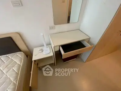 Compact bedroom with minimalist furniture and open drawer