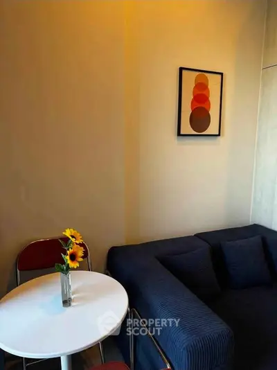 Cozy living room with modern sofa and stylish wall art, perfect for relaxation.