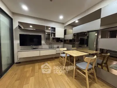 Modern living room with sleek wooden flooring and stylish dining area