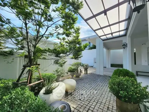 Stunning modern garden entrance with lush greenery and sleek design elements.