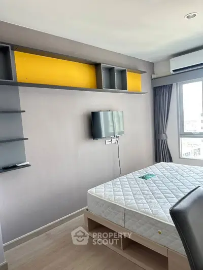 Modern bedroom with wall-mounted TV and stylish shelving