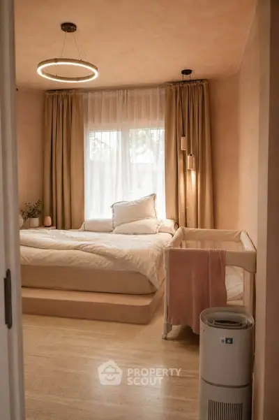 Cozy bedroom with elegant lighting and soft curtains, perfect for a serene retreat.