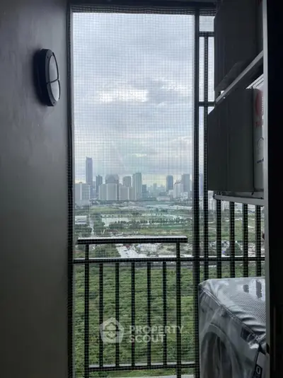 High-rise balcony with stunning cityscape view and laundry area.