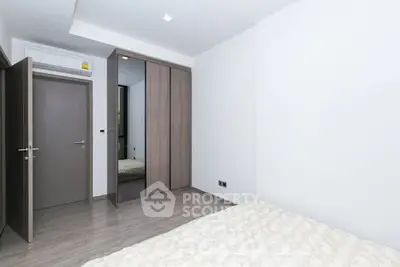 Modern minimalist bedroom with sleek wardrobe and neutral tones