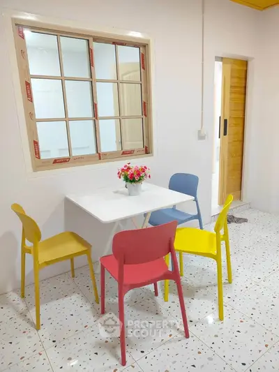 Charming dining area with colorful chairs and modern decor