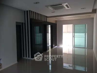 Spacious modern living room with sleek design and large windows for natural light.