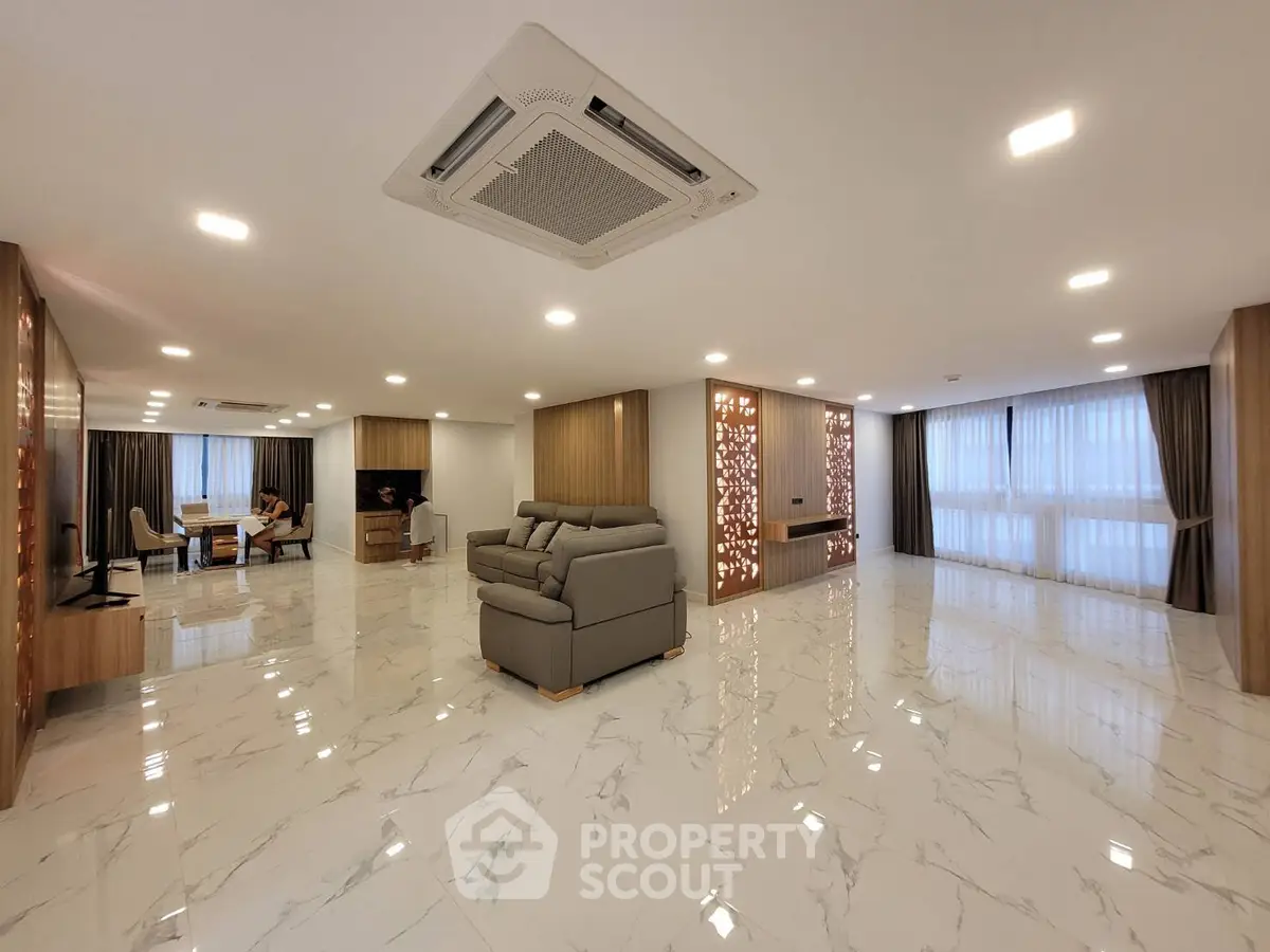 Spacious modern living room with elegant marble flooring and stylish decor