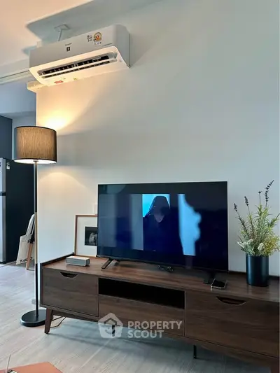 Modern living room with stylish TV stand and air conditioning unit