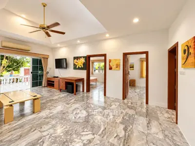 Spacious living room with marble flooring and modern decor in a luxury home.
