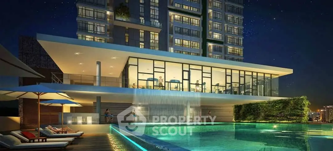 Luxurious modern building with illuminated pool and stunning night view.