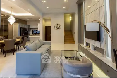 Luxurious open-plan living room with elegant dining area and modern decor