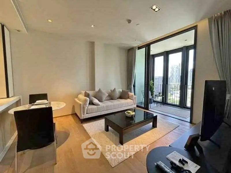 Modern living room with elegant decor and balcony view in upscale apartment.