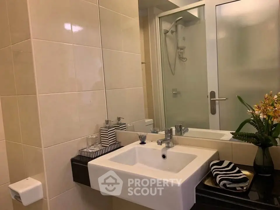 Modern bathroom with sleek sink and glass shower enclosure