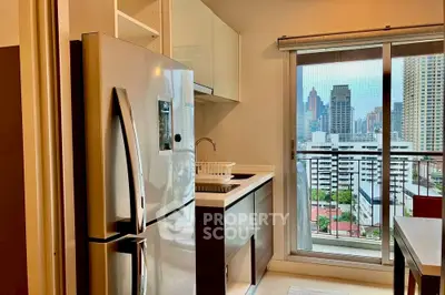 Modern kitchen with city view, featuring sleek appliances and balcony access.