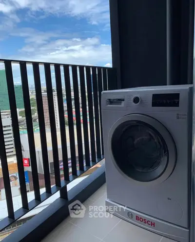 Modern balcony with Bosch washing machine and city view, perfect for urban living convenience.