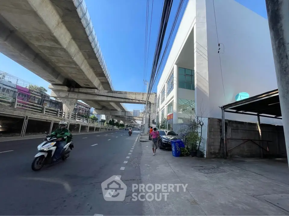 Urban street view with modern building and elevated train tracks