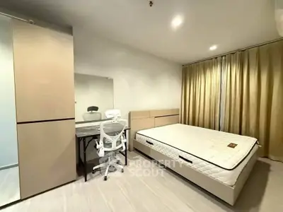 Modern bedroom with minimalist design, featuring a comfortable bed, sleek wardrobe, and stylish desk chair.