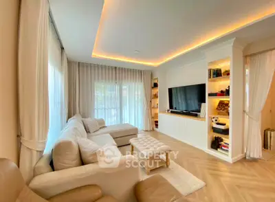 Spacious living room with elegant lighting and cozy seating area, perfect for relaxation and entertainment.