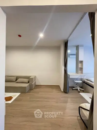 Modern minimalist living room with wooden flooring and cozy sofa