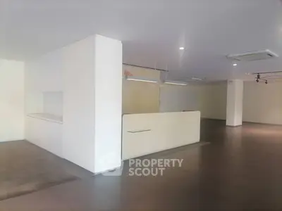 Spacious modern interior with sleek design and ample lighting, perfect for versatile commercial use.