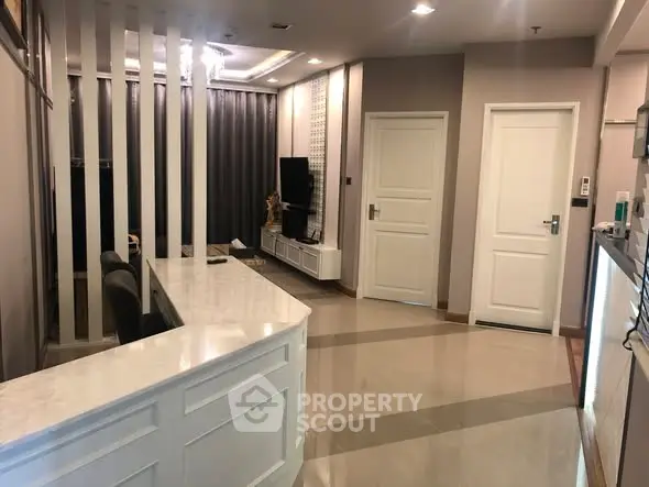 Modern living room with sleek design and open layout, featuring stylish decor and ample natural light.