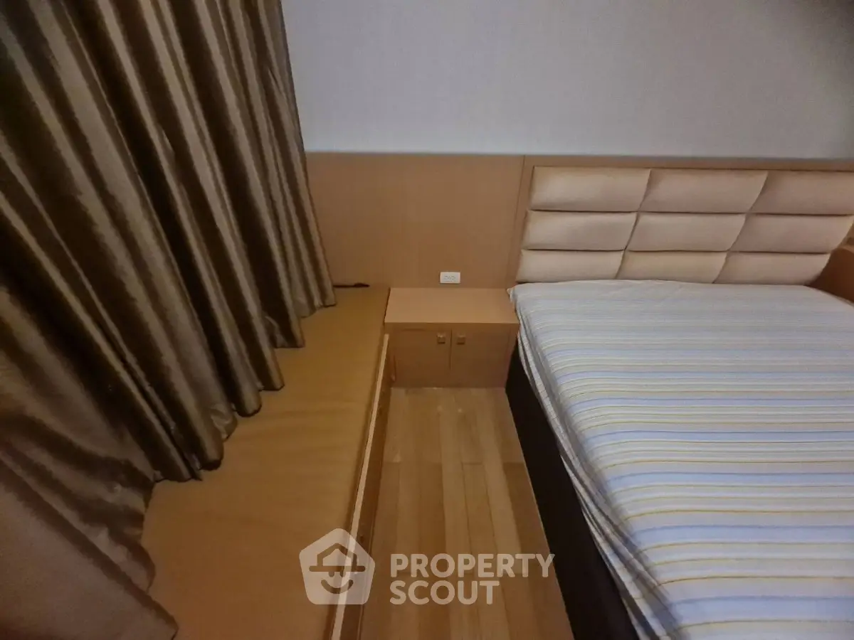 Cozy bedroom with stylish headboard and elegant curtains, perfect for restful nights.