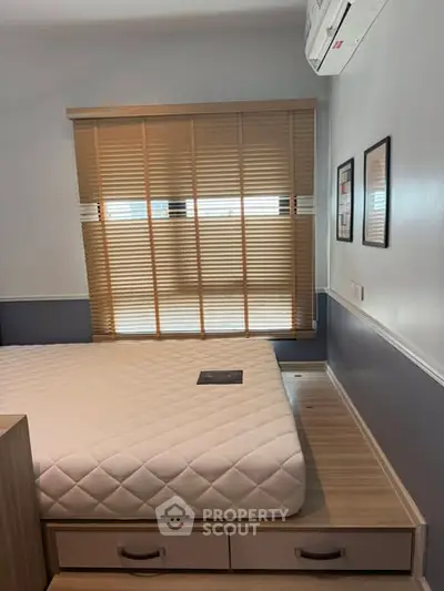 Cozy bedroom with modern design featuring a comfortable bed and stylish window blinds.