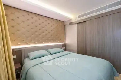Luxurious bedroom with elegant tufted headboard and soft lighting, perfect for relaxation.
