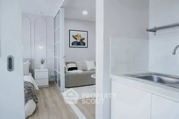 Modern apartment interior with cozy living room and sleek kitchen area.