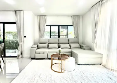 Modern living room with elegant white sofa and large windows