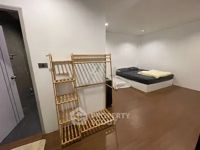 Spacious bedroom with minimalist decor and wooden flooring
