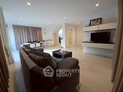 Spacious modern living room with sleek furniture and elegant dining area.