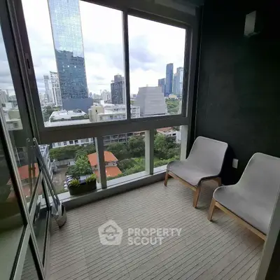 Modern balcony with city skyline view and cozy seating area.
