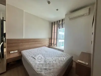 Modern bedroom with large window and air conditioning in urban apartment