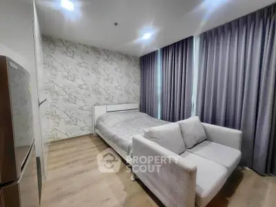Modern bedroom with stylish decor and cozy sofa in a contemporary apartment.